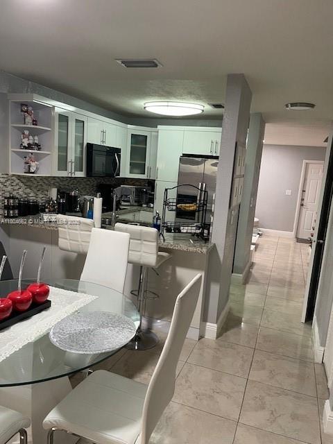 8340 NW 8th St Unit N12, Miami, FL 33126 - dining area with baseboards and light tile patterned flooring