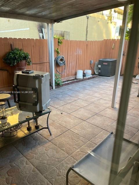 8340 NW 8th St Unit N12, Miami, FL 33126 - view of patio with central AC unit and fence