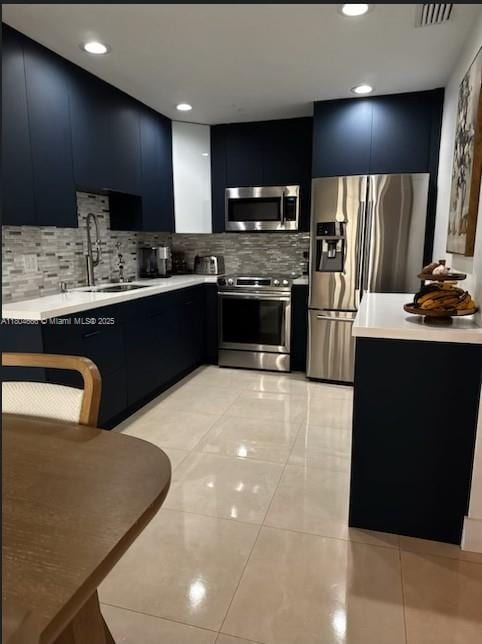 6950 NW 168th St, Hialeah, FL 33015 - kitchen featuring stainless steel appliances, dark cabinets, a sink, light countertops, and modern cabinets