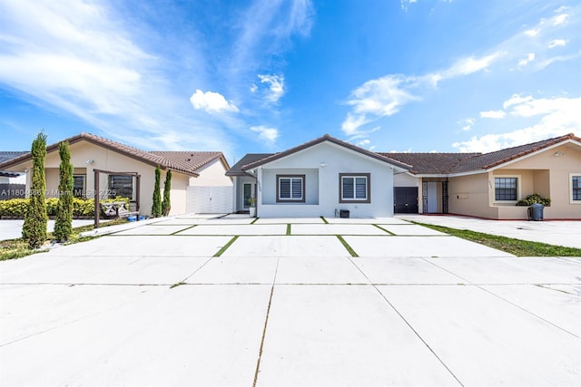 6950 NW 168th St, Hialeah, FL 33015 - ranch-style house with stucco siding, a tiled roof, and driveway