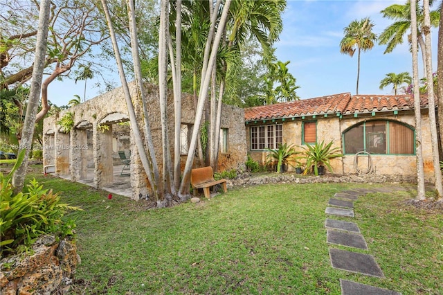 1301 Milan Ave, Villa Coral Gables, FL 33134 - view of front of property featuring a tiled roof, a front yard, and stucco siding