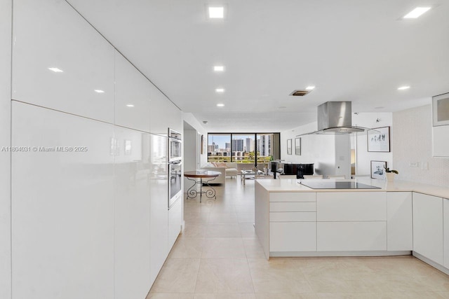 20355 NE 34th Ct Unit 929, Aventura, FL 33180 - kitchen with modern cabinets, wall chimney exhaust hood, black electric cooktop, open floor plan, and a wall of windows