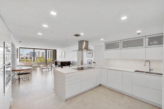 20355 NE 34th Ct Unit 929, Aventura, FL 33180 - kitchen with modern cabinets, black electric stovetop, expansive windows, island range hood, and open floor plan