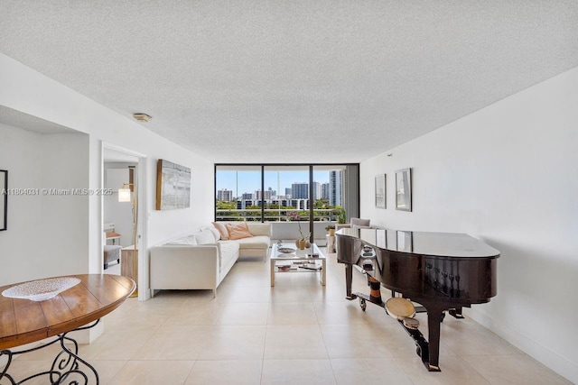 20355 NE 34th Ct Unit 929, Aventura, FL 33180 - living area featuring a view of skyline, a textured ceiling, light tile patterned floors, a wall of windows, and baseboards