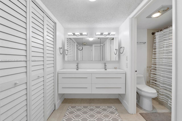 20355 NE 34th Ct Unit 929, Aventura, FL 33180 - full bathroom featuring tile patterned flooring, a textured ceiling, double vanity, toilet, and a closet