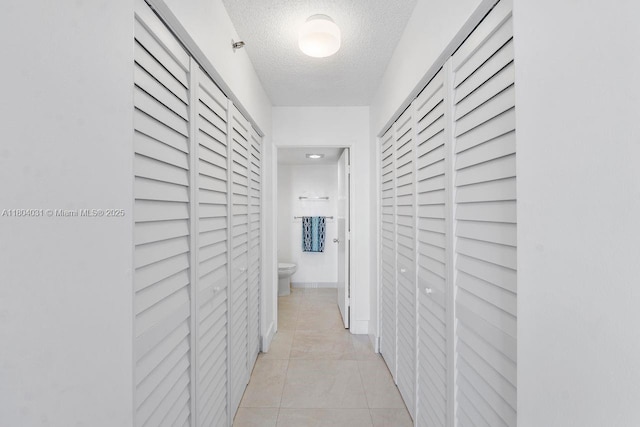 20355 NE 34th Ct Unit 929, Aventura, FL 33180 - hall featuring a textured ceiling and light tile patterned flooring