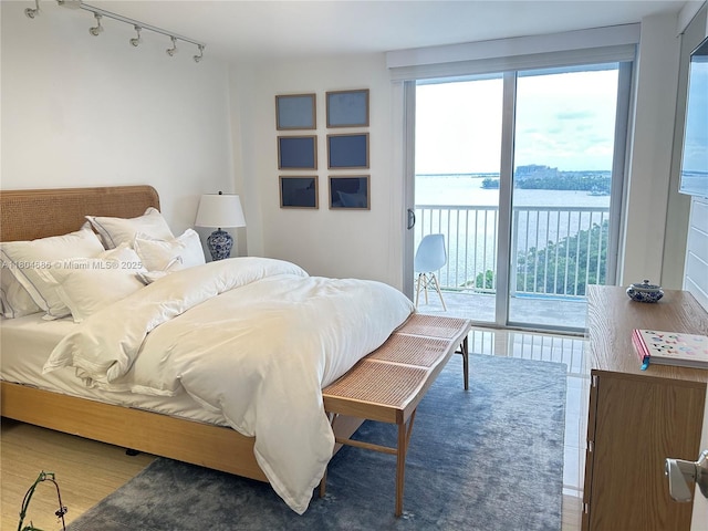 150 SE 25th Rd Unit 14H, Miami, FL 33129 - bedroom featuring rail lighting, access to outside, multiple windows, and wood finished floors