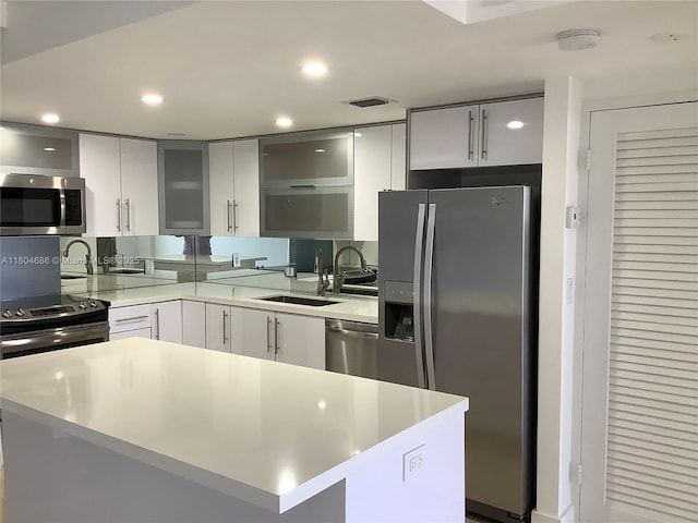 150 SE 25th Rd Unit 14H, Miami, FL 33129 - kitchen with stainless steel appliances, light countertops, a sink, recessed lighting, and glass insert cabinets