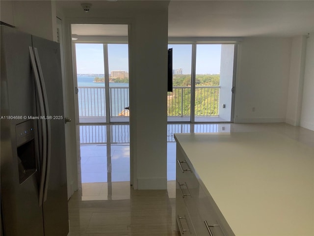 150 SE 25th Rd Unit 14H, Miami, FL 33129 - kitchen featuring stainless steel fridge, a water view, white cabinetry, and light countertops