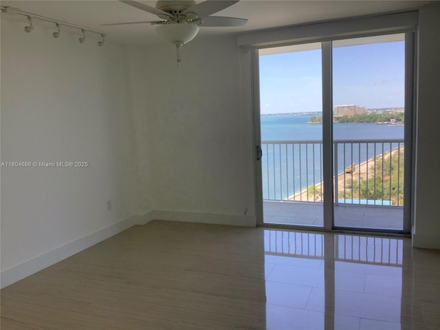 150 SE 25th Rd Unit 14H, Miami, FL 33129 - empty room with a water view, track lighting, ceiling fan, and plenty of natural light