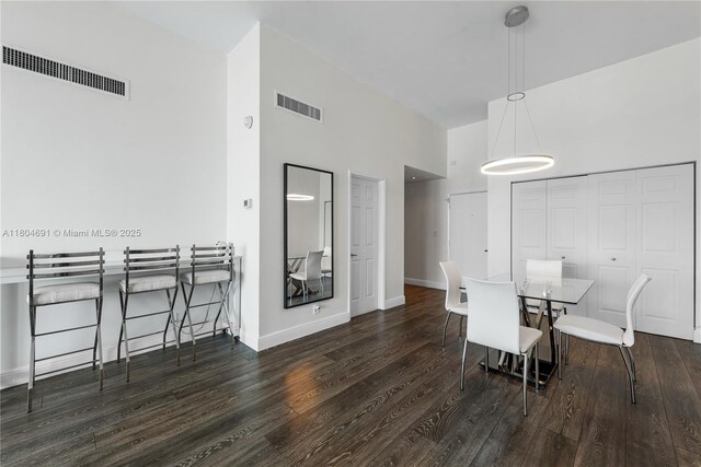 6770 Indian Creek Dr Unit Tsa1, Miami Beach, FL 33141 - dining area with a towering ceiling, wood finished floors, and baseboards