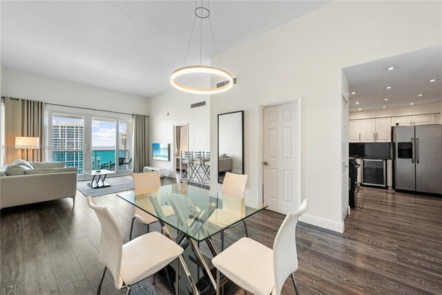 6770 Indian Creek Dr Unit Tsa1, Miami Beach, FL 33141 - dining room featuring dark wood finished floors, beverage cooler, recessed lighting, and baseboards