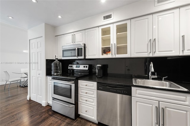 6770 Indian Creek Dr Unit Tsa1, Miami Beach, FL 33141 - kitchen with appliances with stainless steel finishes, dark countertops, a sink, white cabinets, and recessed lighting