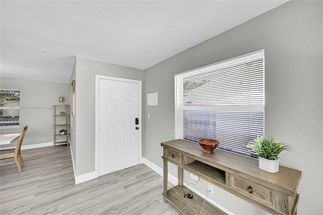 1950 NE 55th Ct, Fort Lauderdale, FL 33308 - foyer entrance with baseboards and light wood-type flooring