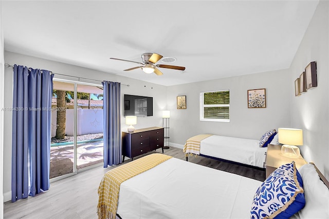 1950 NE 55th Ct, Fort Lauderdale, FL 33308 - bedroom featuring access to outside, wood finished floors, multiple windows, and baseboards