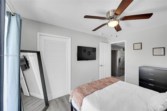 1950 NE 55th Ct, Fort Lauderdale, FL 33308 - bedroom featuring stainless steel fridge with ice dispenser, light wood finished floors, a ceiling fan, a closet, and baseboards