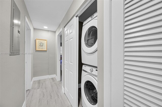 1950 NE 55th Ct, Fort Lauderdale, FL 33308 - laundry room featuring stacked washer / dryer, baseboards, electric panel, light wood-style flooring, and recessed lighting