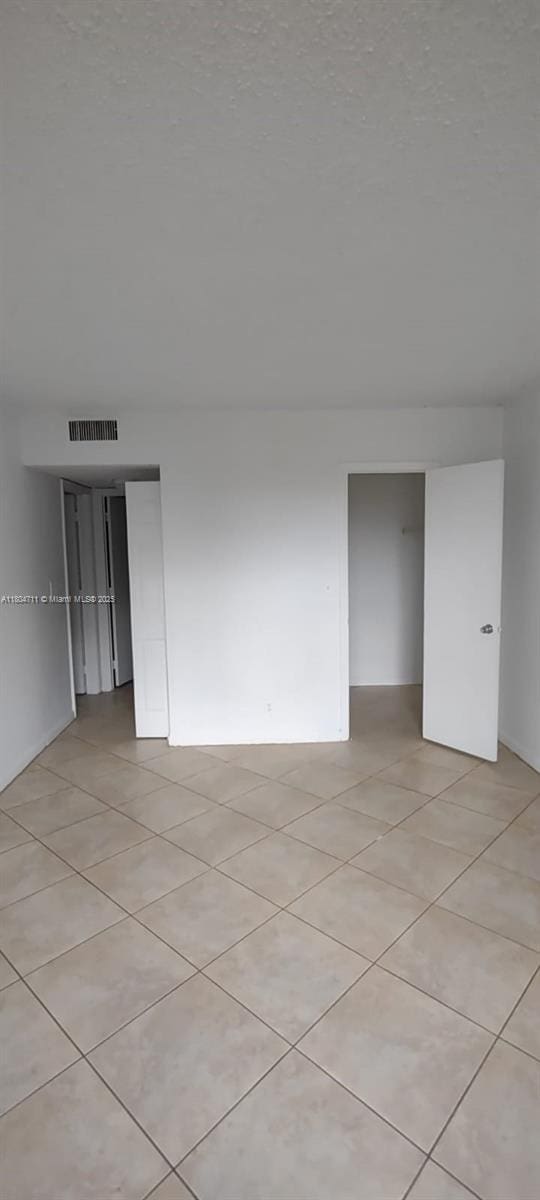 empty room with light tile patterned floors
