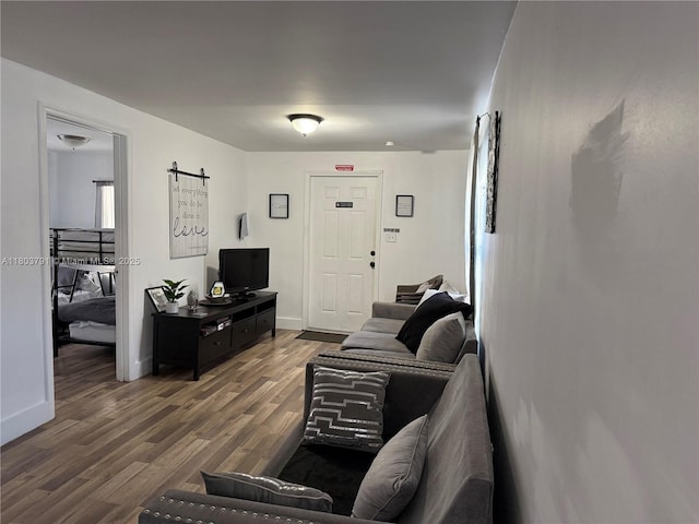 1463 NW 70th St, Miami, FL 33147 - living area with wood finished floors, baseboards, and a barn door
