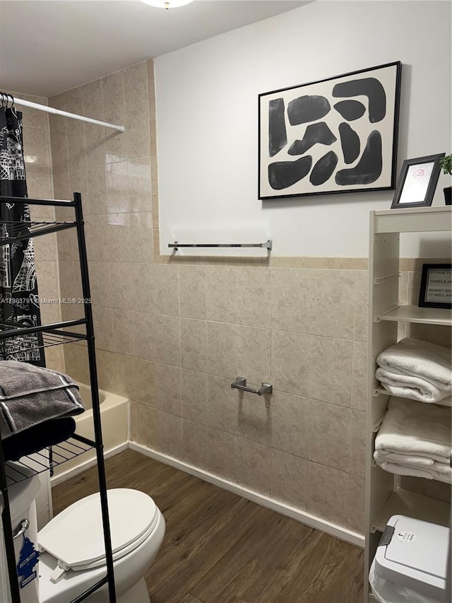 1463 NW 70th St, Miami, FL 33147 - bathroom featuring tile walls, wood finished floors, toilet, and tiled shower