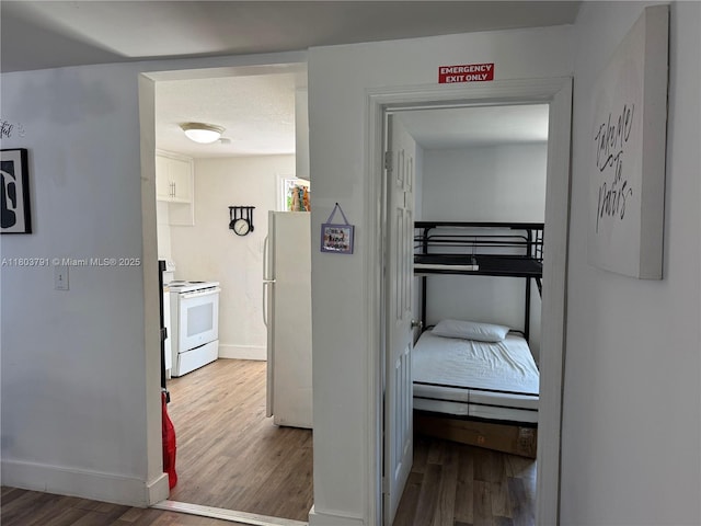 1463 NW 70th St, Miami, FL 33147 - bedroom featuring freestanding refrigerator, wood finished floors, and baseboards