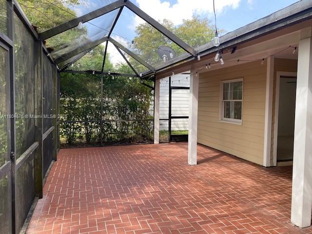 14953 SW 143rd Ct, Miami, FL 33186 - view of patio featuring glass enclosure