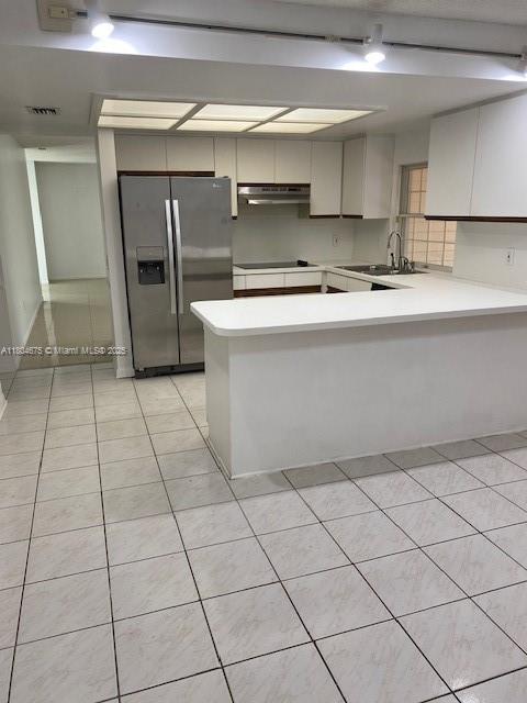 14953 SW 143rd Ct, Miami, FL 33186 - kitchen with stainless steel refrigerator with ice dispenser, under cabinet range hood, light countertops, a peninsula, and a sink