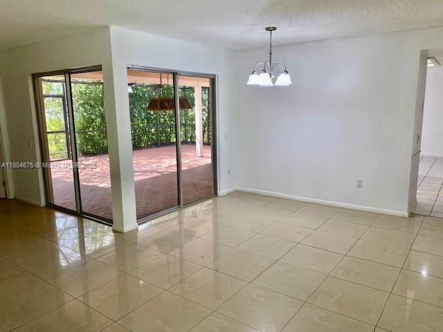 14953 SW 143rd Ct, Miami, FL 33186 - empty room featuring a chandelier, light tile patterned floors, baseboards, and a textured ceiling