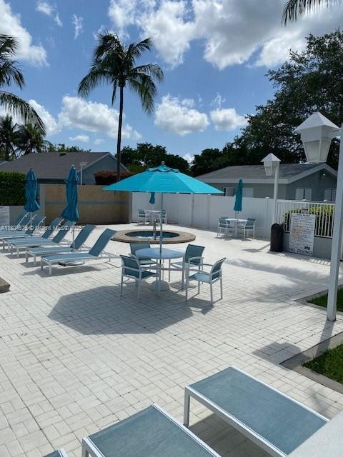 14953 SW 143rd Ct, Miami, FL 33186 - view of patio featuring fence and outdoor dining area