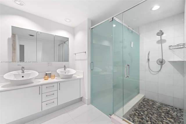 2950 NE 188th St Unit 540, Aventura, FL 33180 - bathroom featuring a shower stall, double vanity, and tile patterned flooring