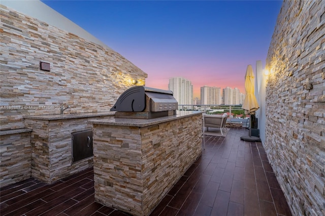 2950 NE 188th St Unit 540, Aventura, FL 33180 - patio terrace at dusk with area for grilling and a view of city