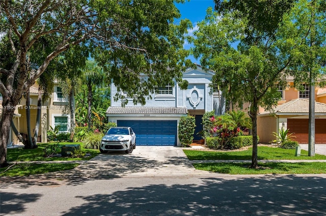 2626 Sawyer Ter, Wellington, FL 33414 - obstructed view of property with concrete driveway, stucco siding, an attached garage, and a tile roof