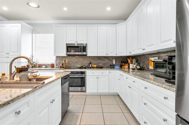2626 Sawyer Ter, Wellington, FL 33414 - kitchen featuring stainless steel appliances, a sink, light tile patterned flooring, white cabinetry, and recessed lighting