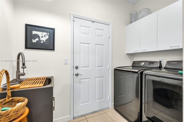 2626 Sawyer Ter, Wellington, FL 33414 - clothes washing area featuring cabinet space, washer and clothes dryer, light tile patterned flooring, and baseboards