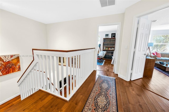 2626 Sawyer Ter, Wellington, FL 33414 - corridor featuring an upstairs landing, wood-type flooring, and baseboards