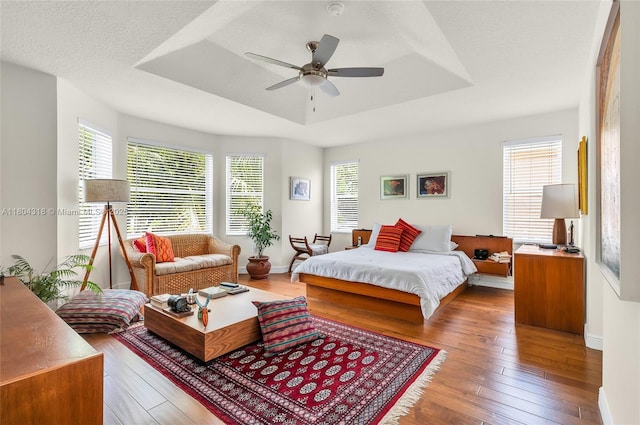 2626 Sawyer Ter, Wellington, FL 33414 - bedroom featuring a tray ceiling, wood-type flooring, baseboards, and ceiling fan