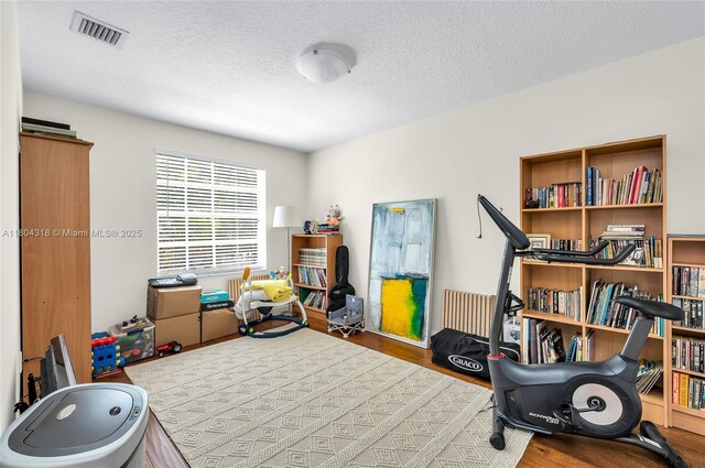 2626 Sawyer Ter, Wellington, FL 33414 - exercise area featuring wood finished floors and a textured ceiling