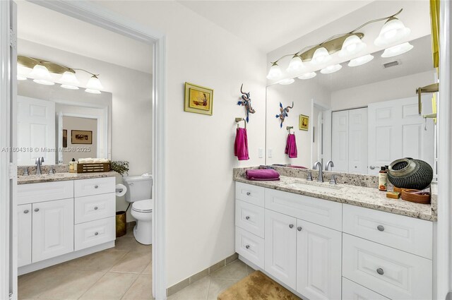 2626 Sawyer Ter, Wellington, FL 33414 - full bathroom with tile patterned floors, two vanities, toilet, and baseboards