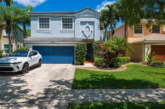 2626 Sawyer Ter, Wellington, FL 33414 - townhome / multi-family property with stucco siding, a tiled roof, and driveway