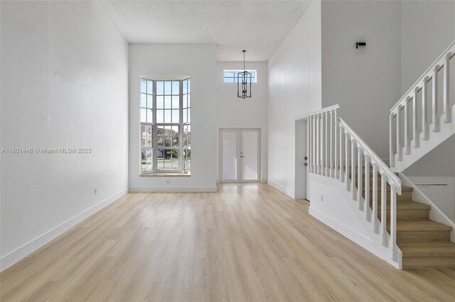 8501 NW 191st St, Hialeah, FL 33015 - kitchen featuring stainless steel appliances, a sink, a textured ceiling, light wood-type flooring, and light countertops