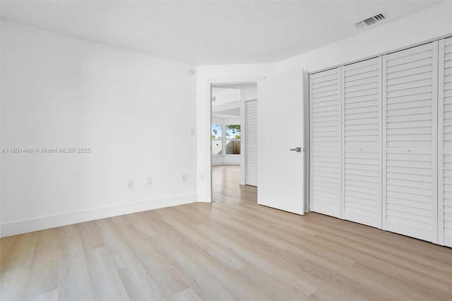 8501 NW 191st St, Hialeah, FL 33015 - unfurnished bedroom featuring wood finished floors, baseboards, and a closet