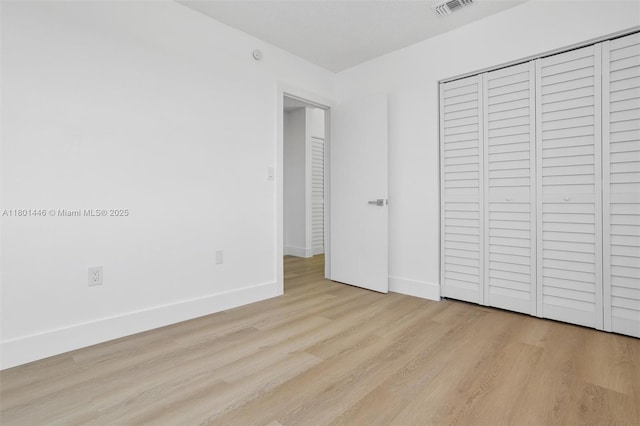 8501 NW 191st St, Hialeah, FL 33015 - unfurnished bedroom with wood finished floors, baseboards, and a closet