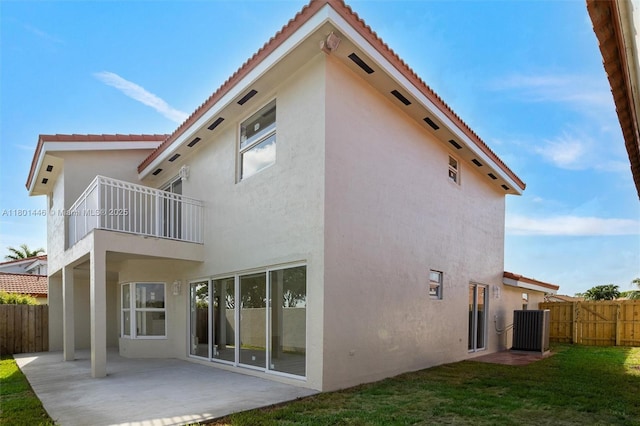 8501 NW 191st St, Hialeah, FL 33015 - rear view of house featuring a balcony, stucco siding, central AC unit, and a patio