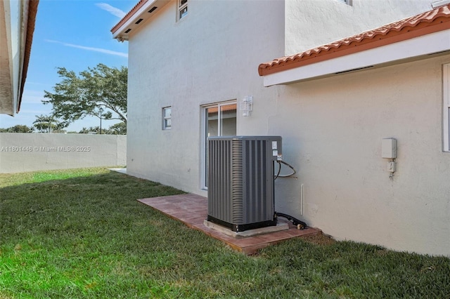 8501 NW 191st St, Hialeah, FL 33015 - view of home's exterior featuring central AC, stucco siding, and a tile roof