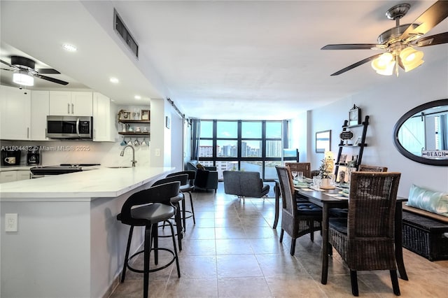 2017 S Ocean Dr Unit 1404, Hallandale Beach, FL 33009 - dining space featuring healthy amount of natural light, a ceiling fan, floor to ceiling windows, recessed lighting, and light tile patterned flooring