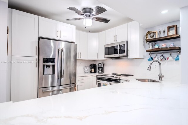 2017 S Ocean Dr Unit 1404, Hallandale Beach, FL 33009 - kitchen featuring stainless steel appliances, a sink, open shelves, light stone counters, and a ceiling fan