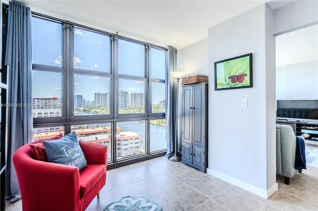 2017 S Ocean Dr Unit 1404, Hallandale Beach, FL 33009 - living area featuring baseboards, light tile patterned flooring, and a city view