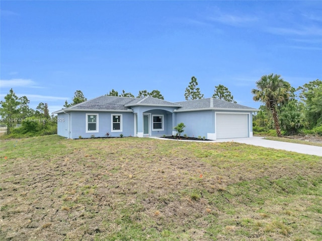 935 Elgin St, Lehigh Acres, FL 33974 - ranch-style house with concrete driveway, a garage, a front yard, and stucco siding