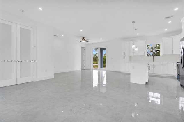935 Elgin St, Lehigh Acres, FL 33974 - unfurnished living room with a ceiling fan and recessed lighting