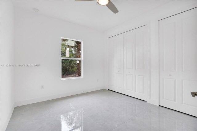 935 Elgin St, Lehigh Acres, FL 33974 - unfurnished bedroom featuring a ceiling fan, baseboards, and tile patterned floors